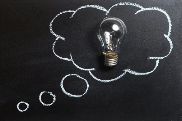 Clear Light Bulb Placed on Chalkboard